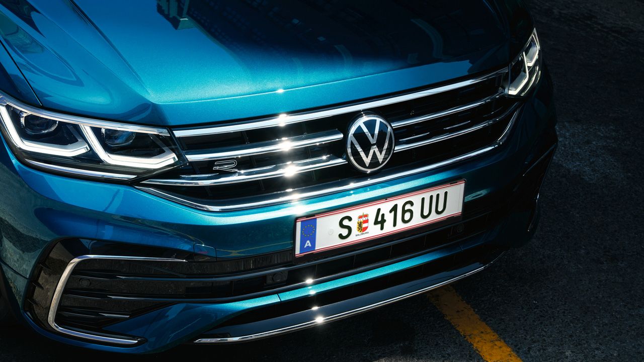 Blauer VW Tiguan in Frontansicht. Blick auf Kühlergrill und Scheinwerfer